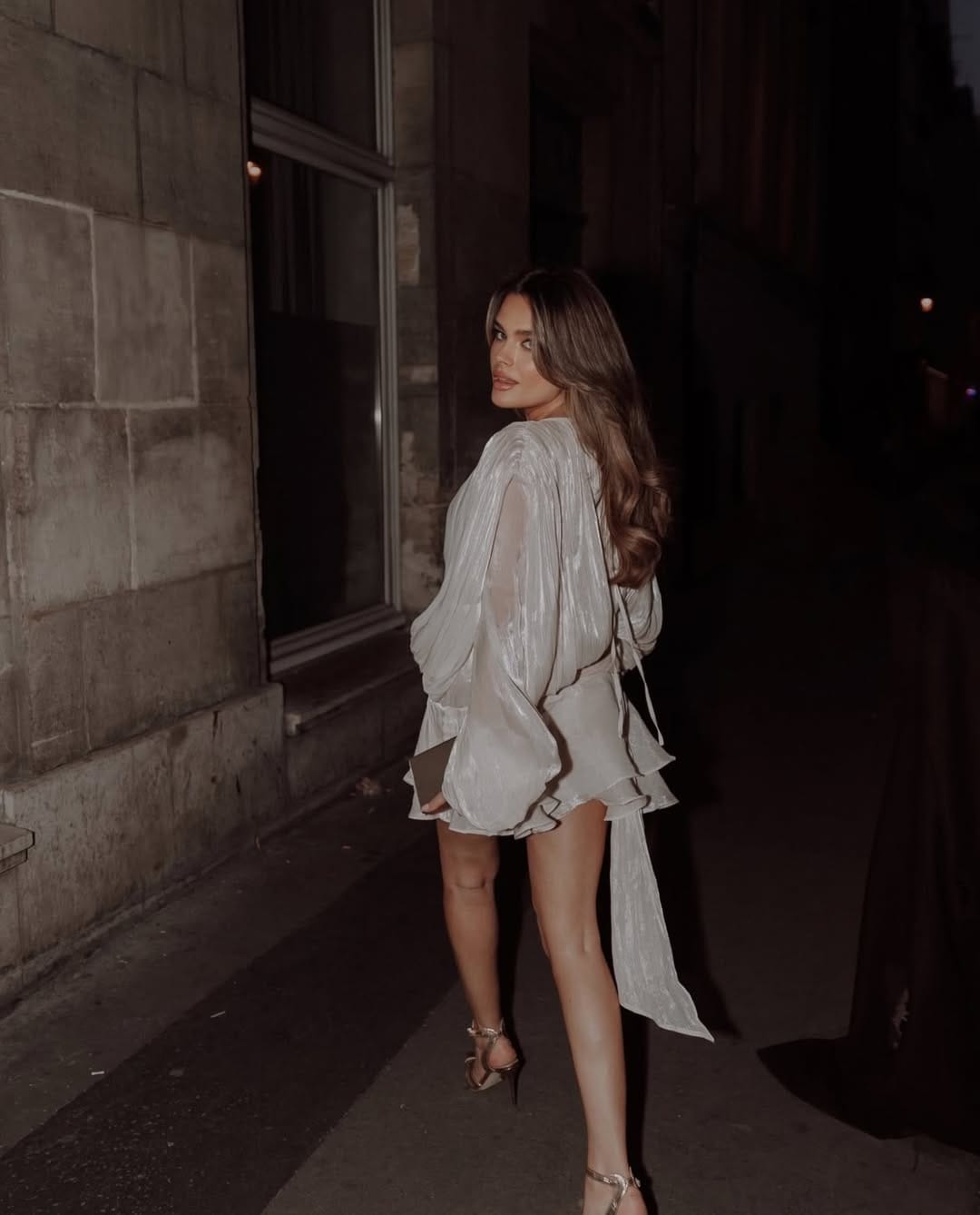 Silver sheer metallic mini dress with ruffle sleeves for a bold night-out look