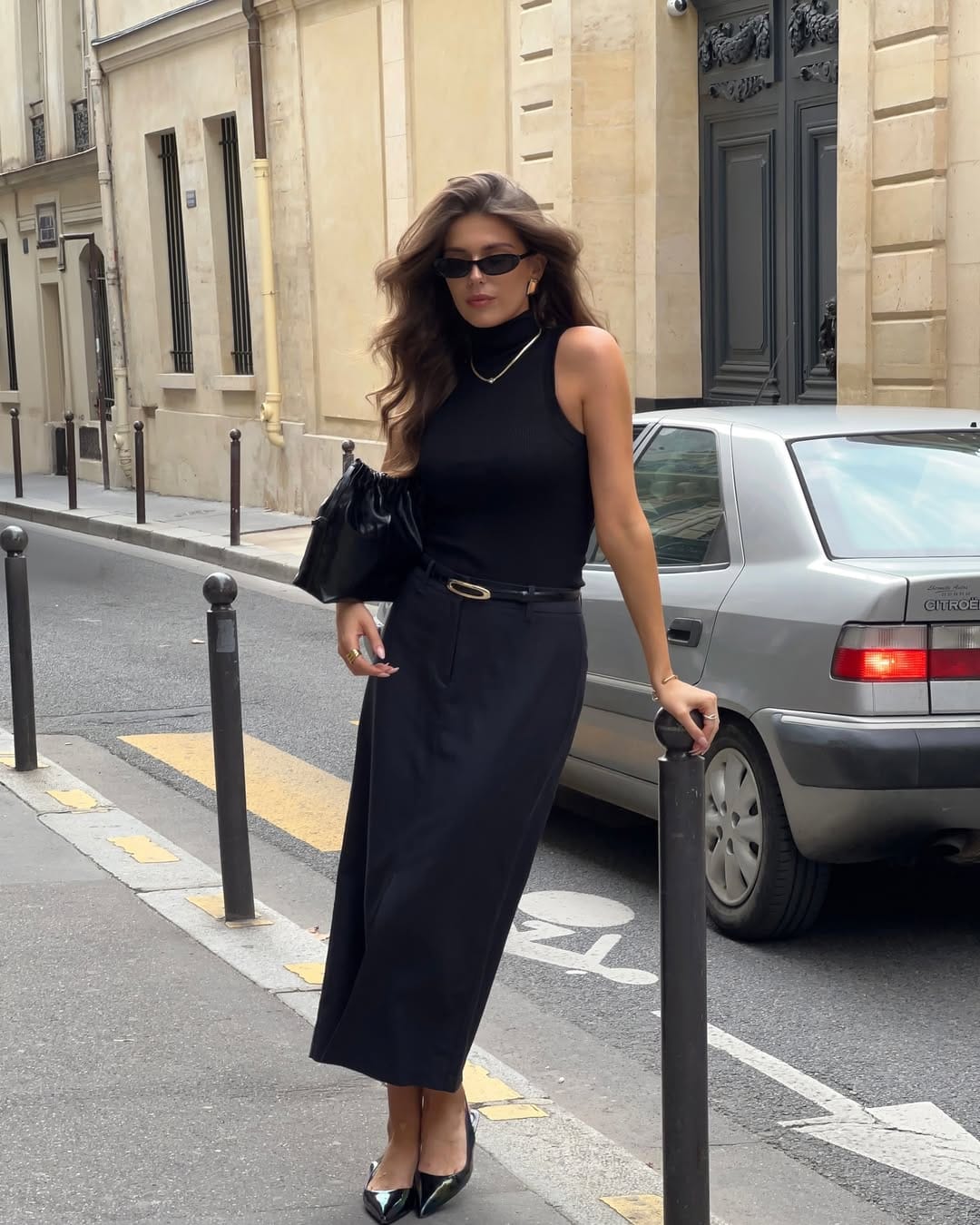 Sleeveless black turtleneck with black midi skirt sleek office outfit