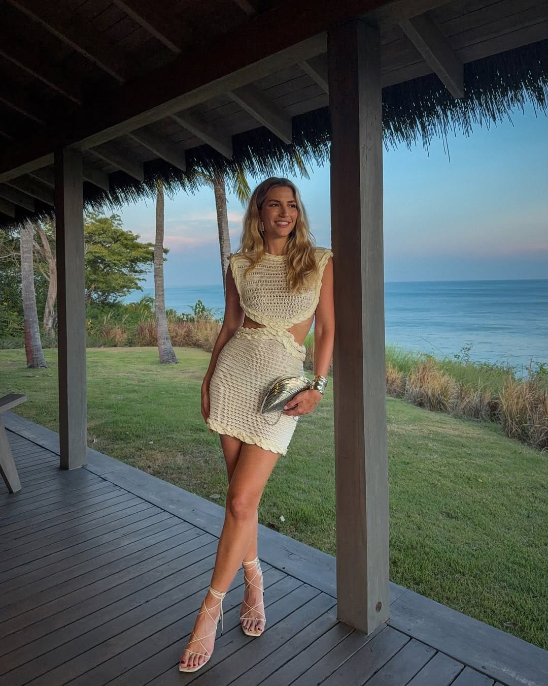 A cream crochet co-ord set with delicate cut-out details, styled with lace-up heels for a breezy, feminine feel.