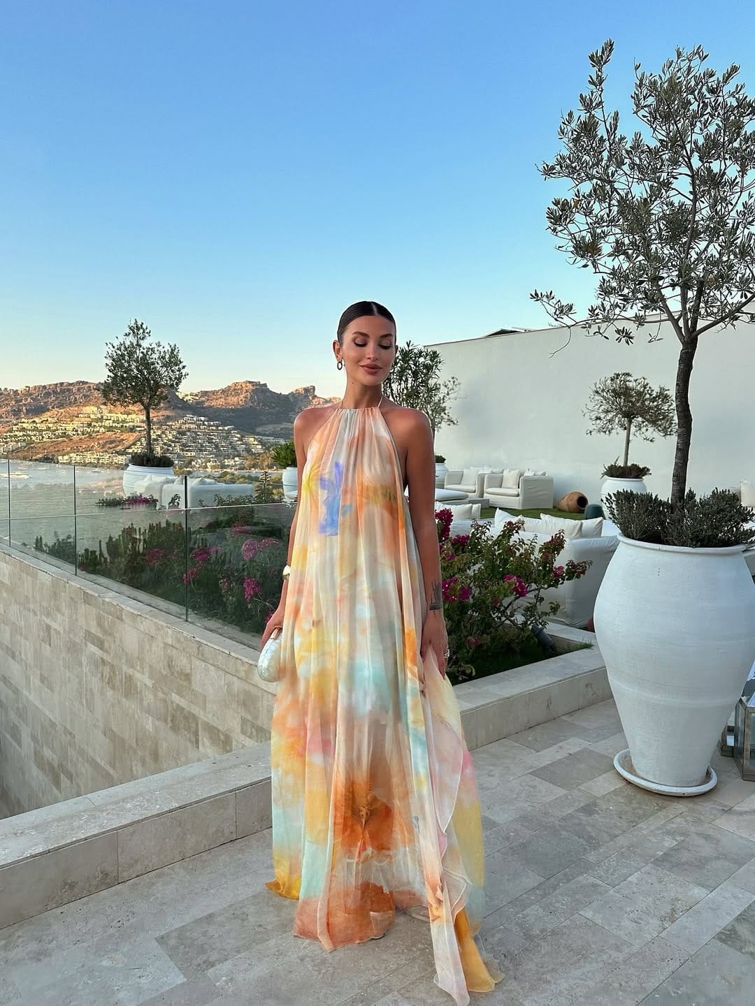 A watercolour print chiffon maxi dress with a halter neckline, offering a light and dreamy resort aesthetic.