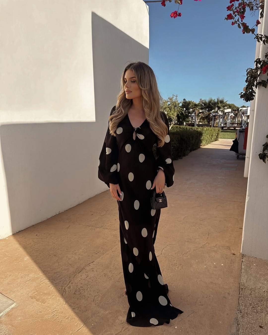 A black and white oversized polka dot column maxi dress with a relaxed silhouette and bold, playful pattern.