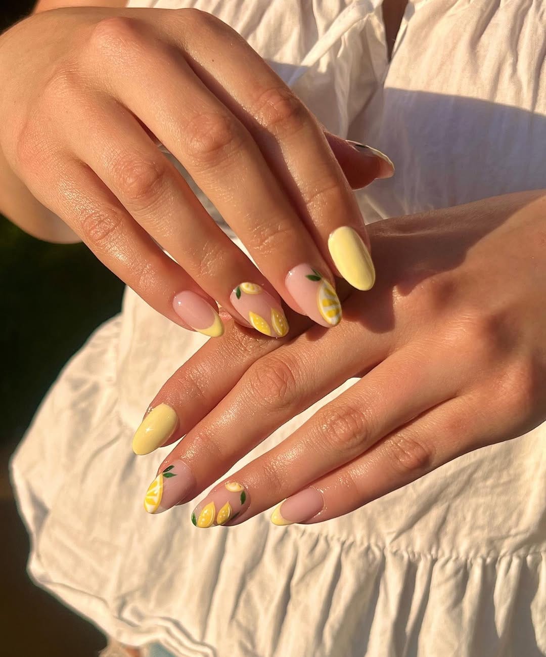 Pastel yellow nails with painted lemon slice details