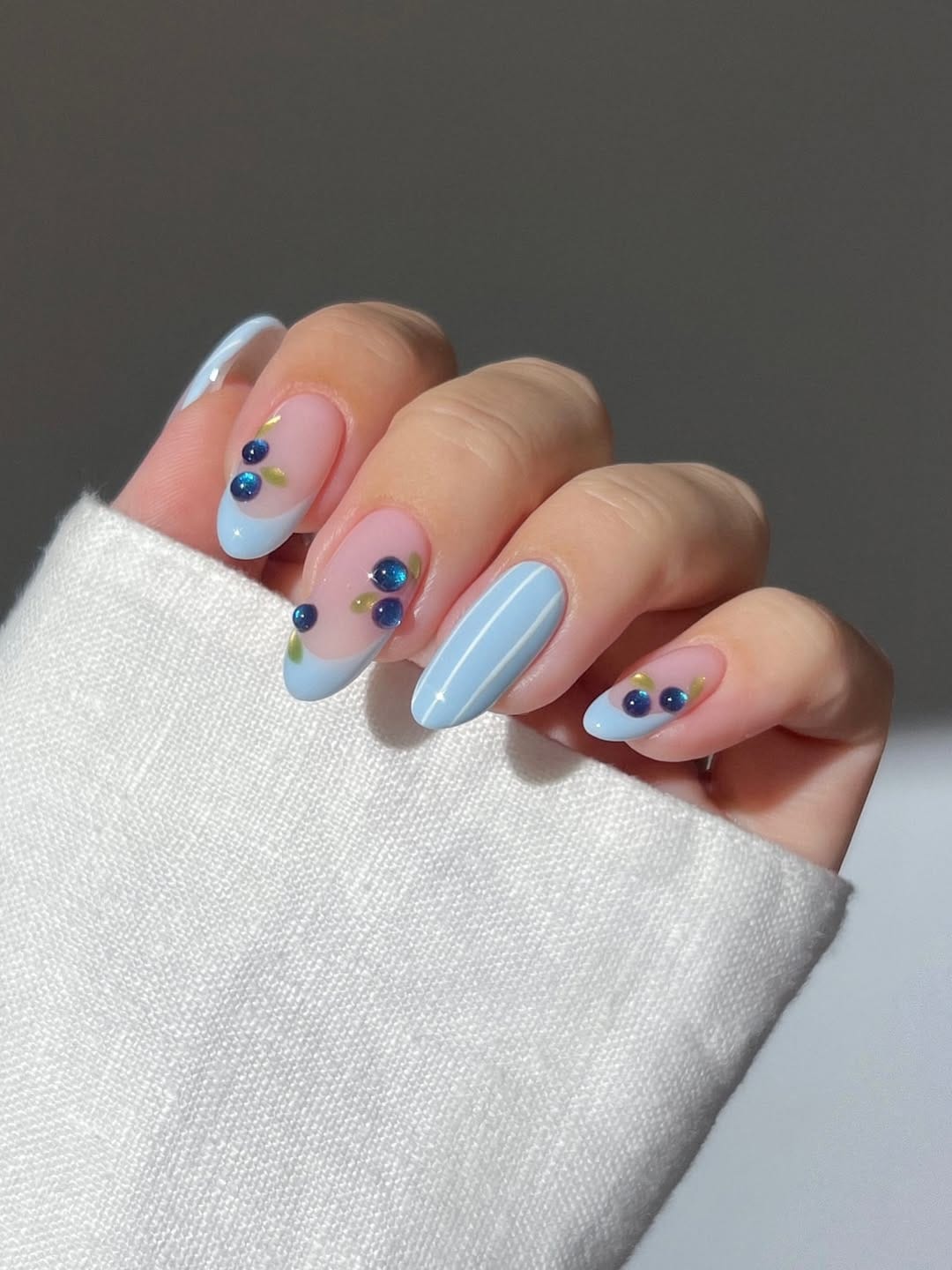 Baby blue French tip nails with blueberry detail for a simple summer nail design