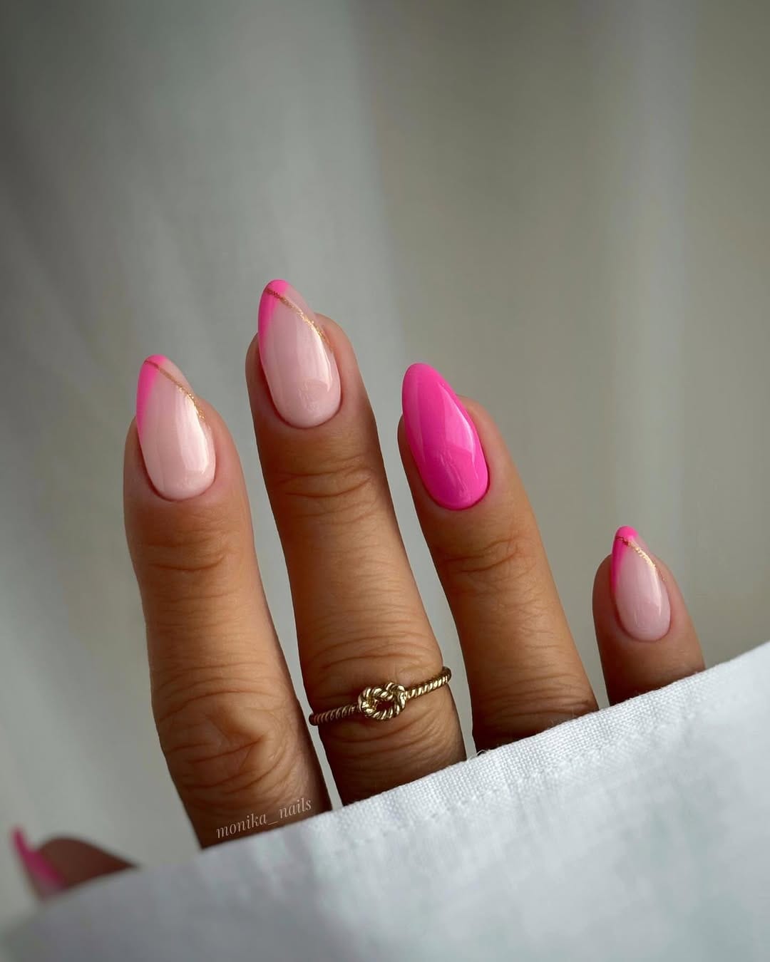 Hot pink and baby pink nails with gold line detail for a simple summer nail idea