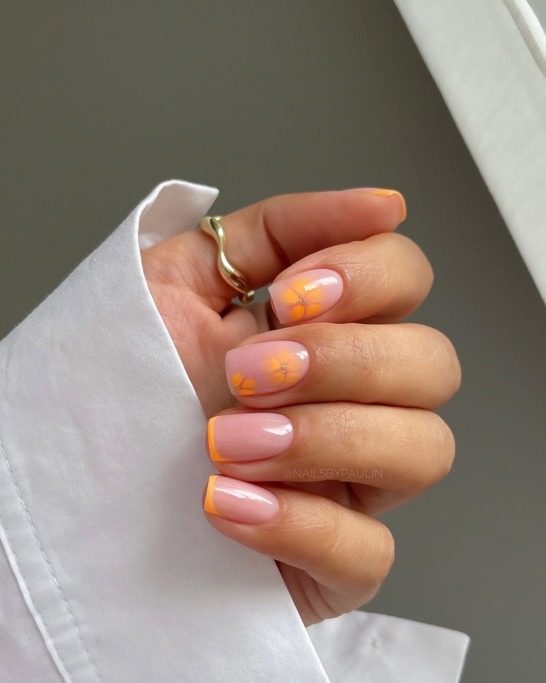 Orange French tip nails with tangerine flower detail for simple summer nails