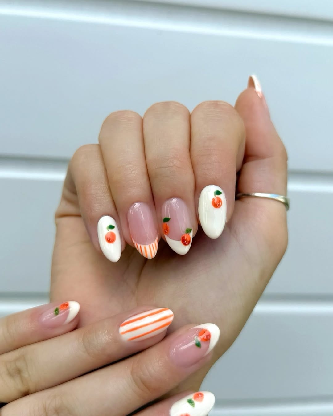 White French tip nails with orange stripe and clementine detail for simple summer nails