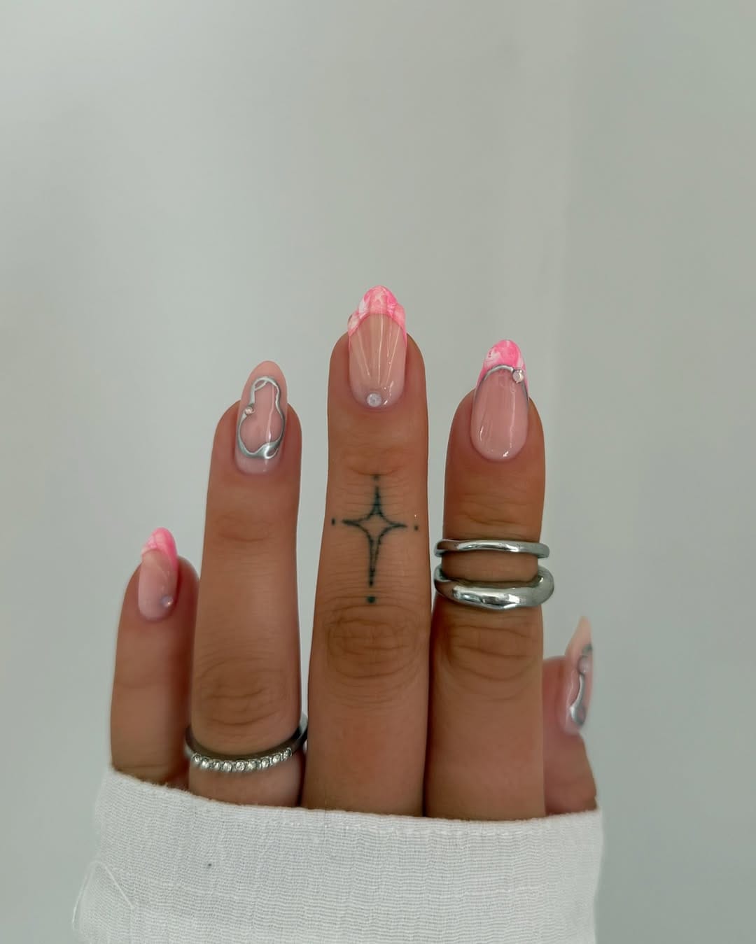 Sheer pink nails with silver cloud and neon marble tips for a simple summer nail design