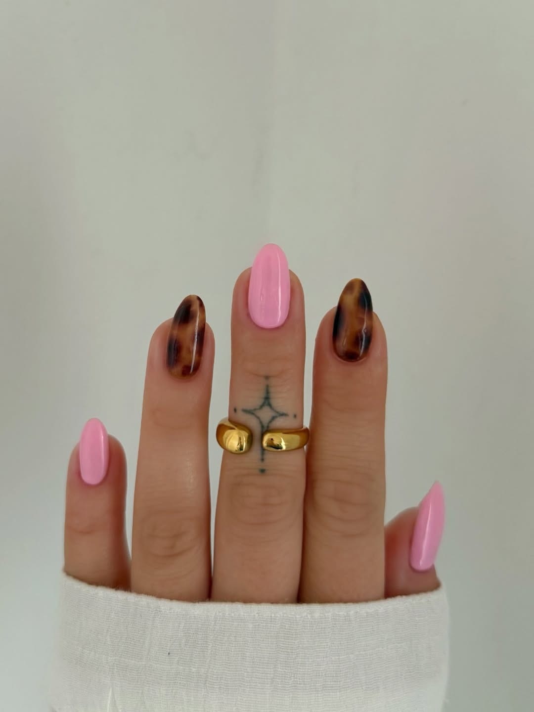 Bubblegum pink nails with tortoiseshell accent for a simple summer nail idea