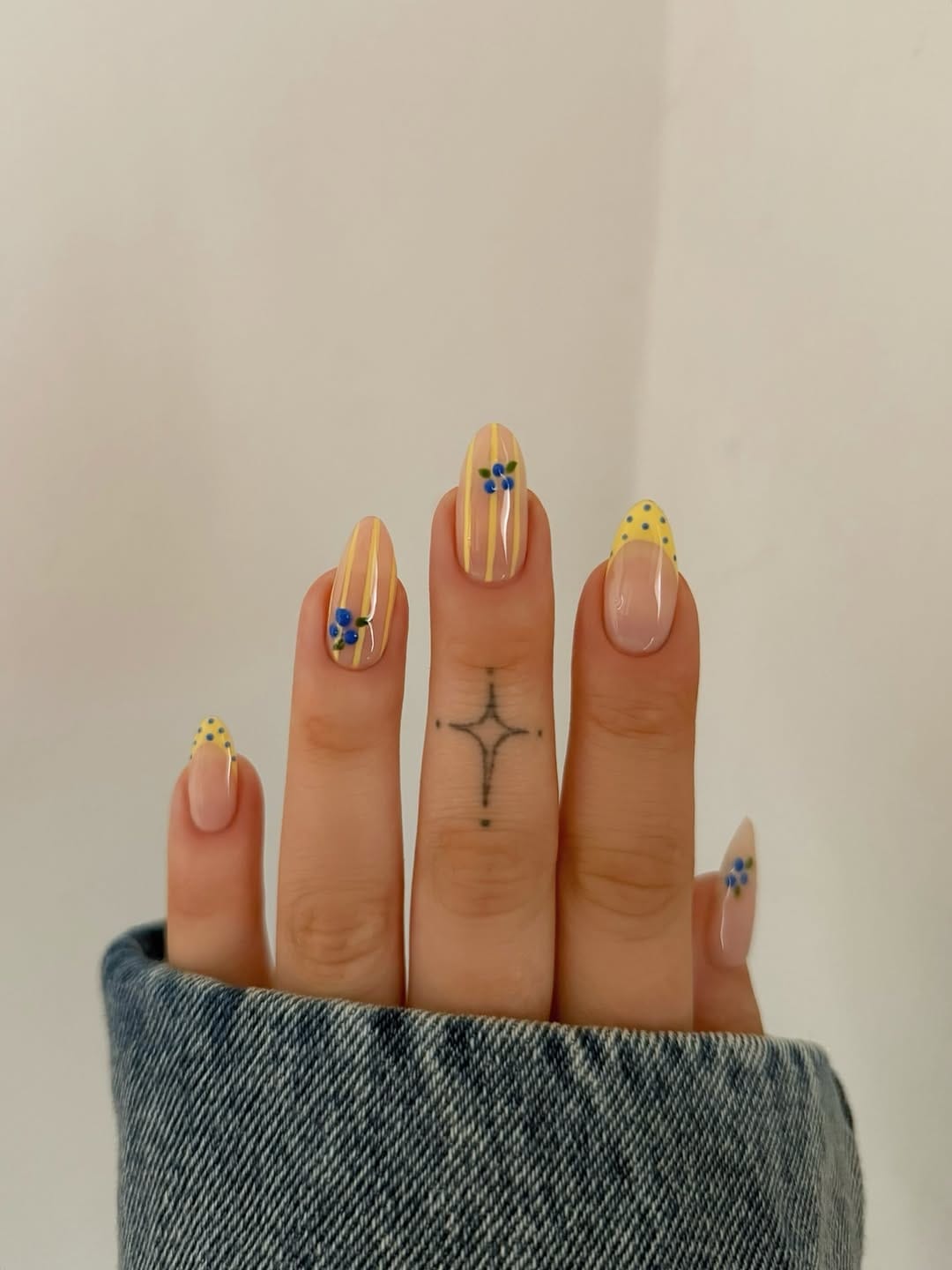 Yellow stripe nails with blueberry French tip for a simple summer nail design
