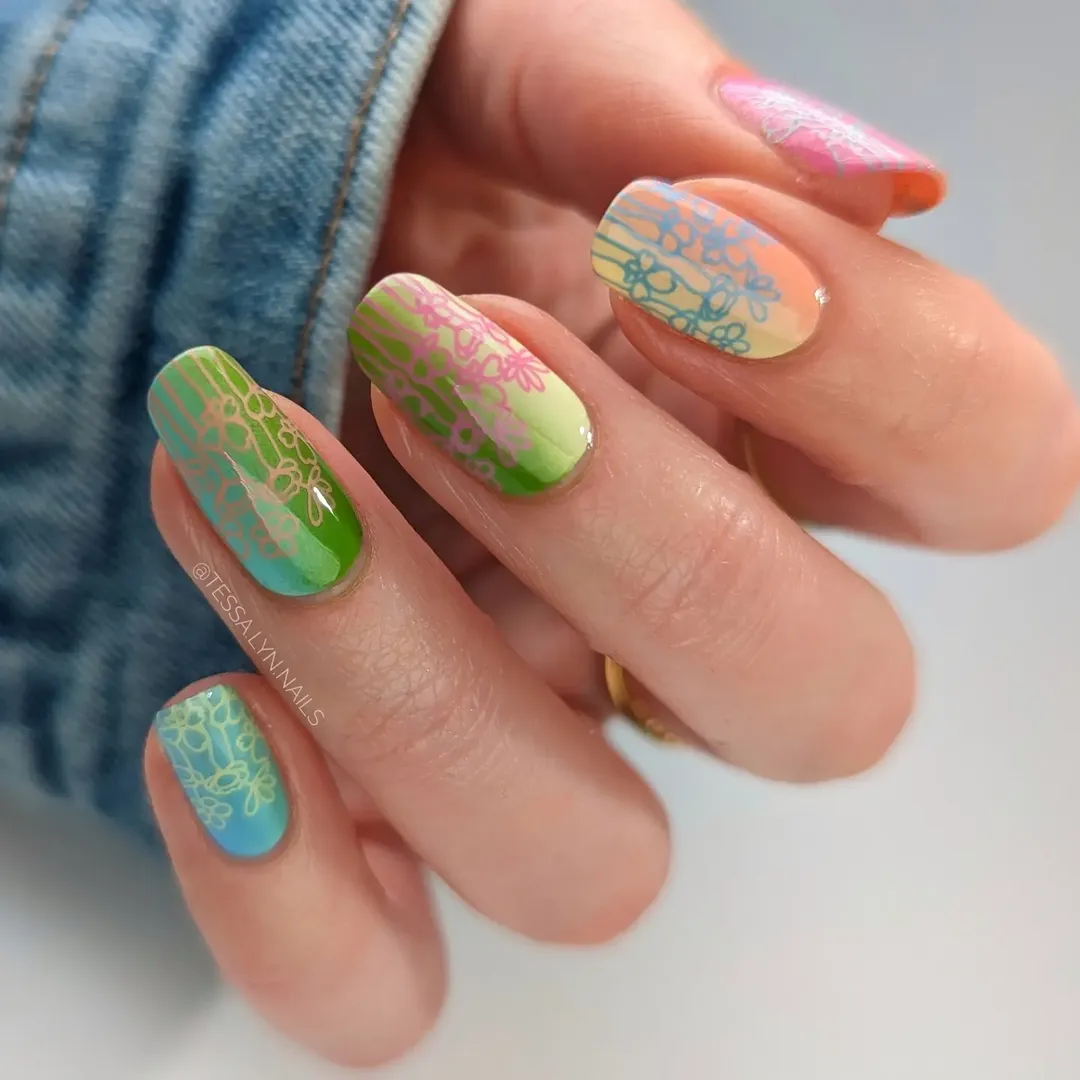 Rainbow gradient nails with daisy doodle detail for simple summer nails