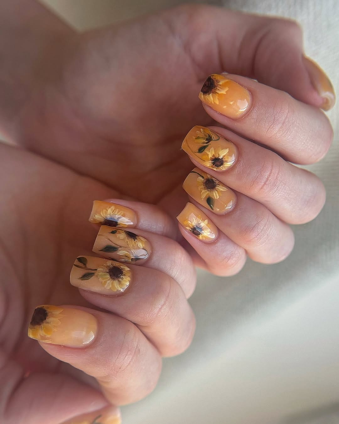 Golden sunflower nail art on almond nails for a simple summer nail design