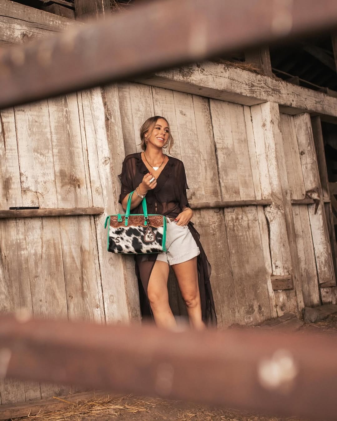 Sheer black duster layered over white denim shorts for a country summer night outfit