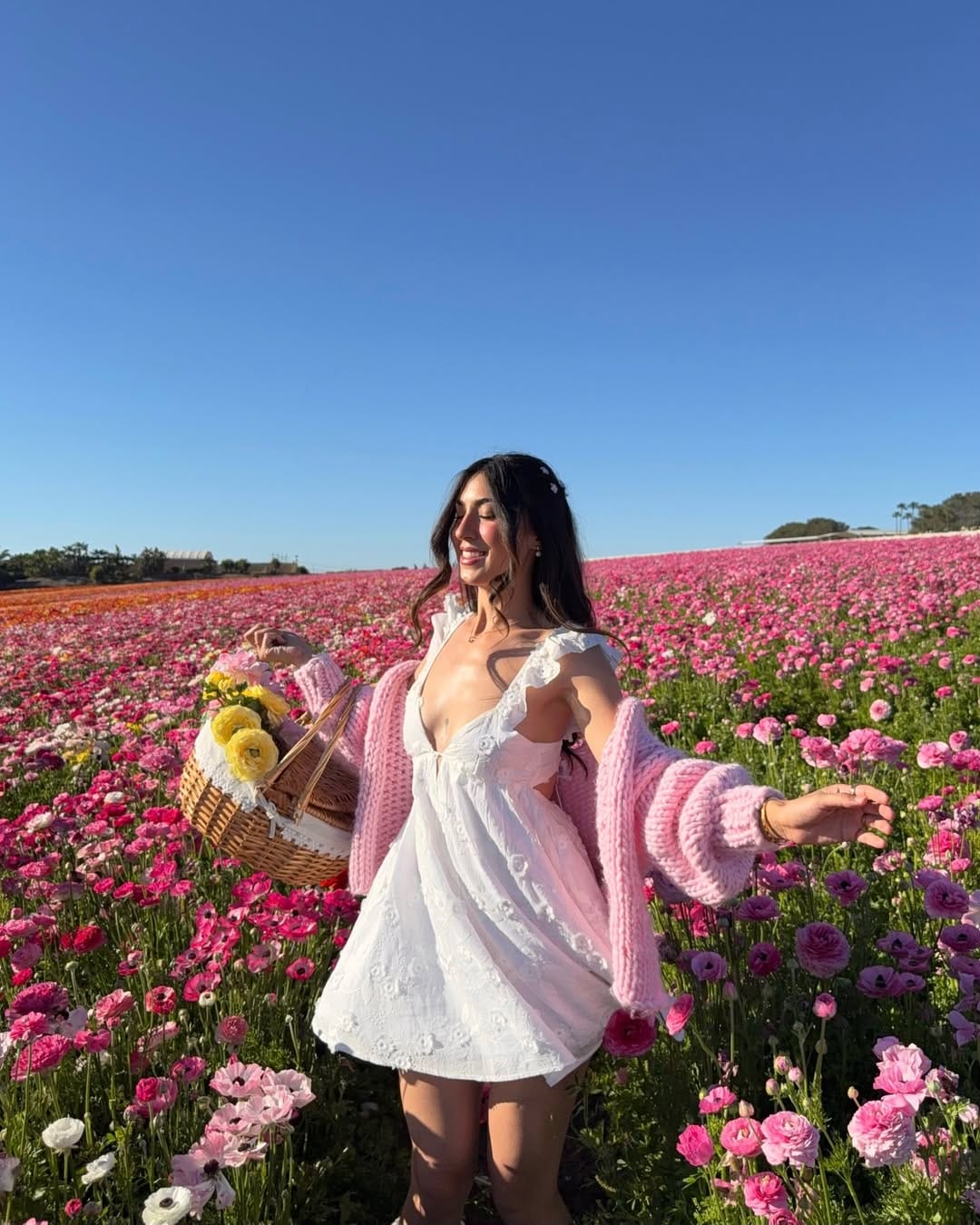 White floral babydoll mini dress with pink knit cardigan for a sweet country summer look