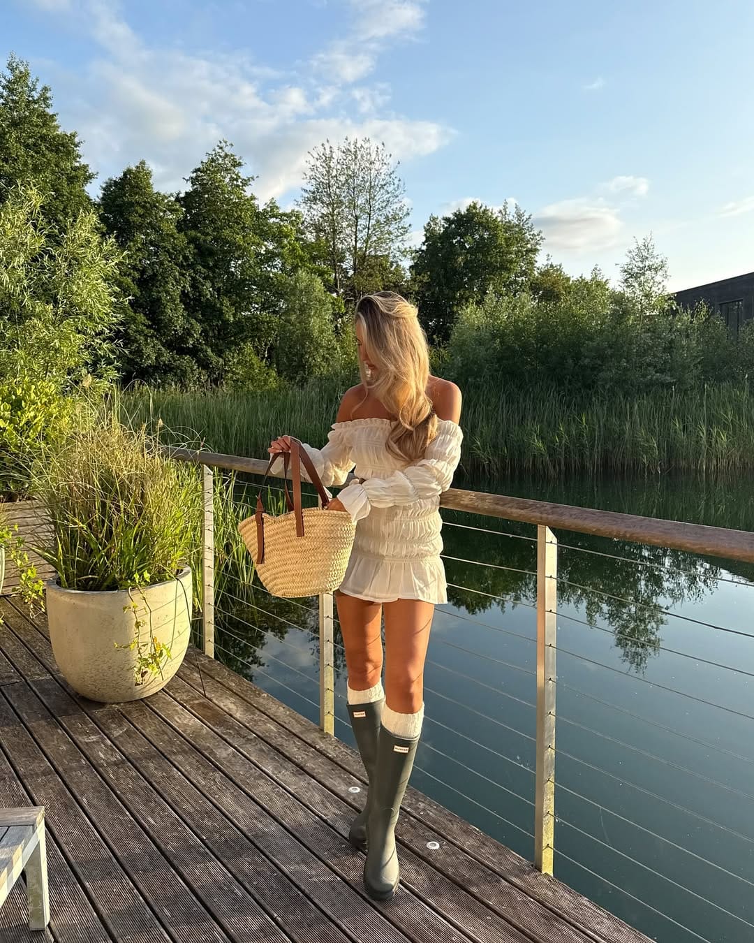 White off-shoulder smocked mini dress with Hunter wellies for a country summer festival outfit