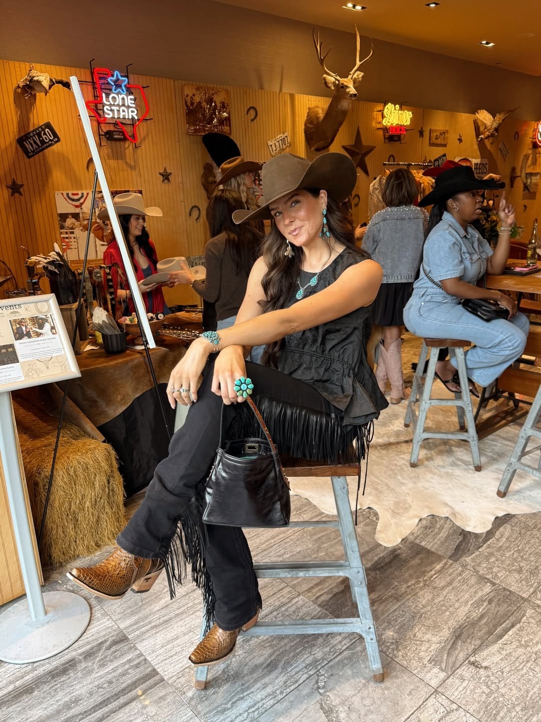 All-black fringe outfit with snake-print boots for a bold country summer look