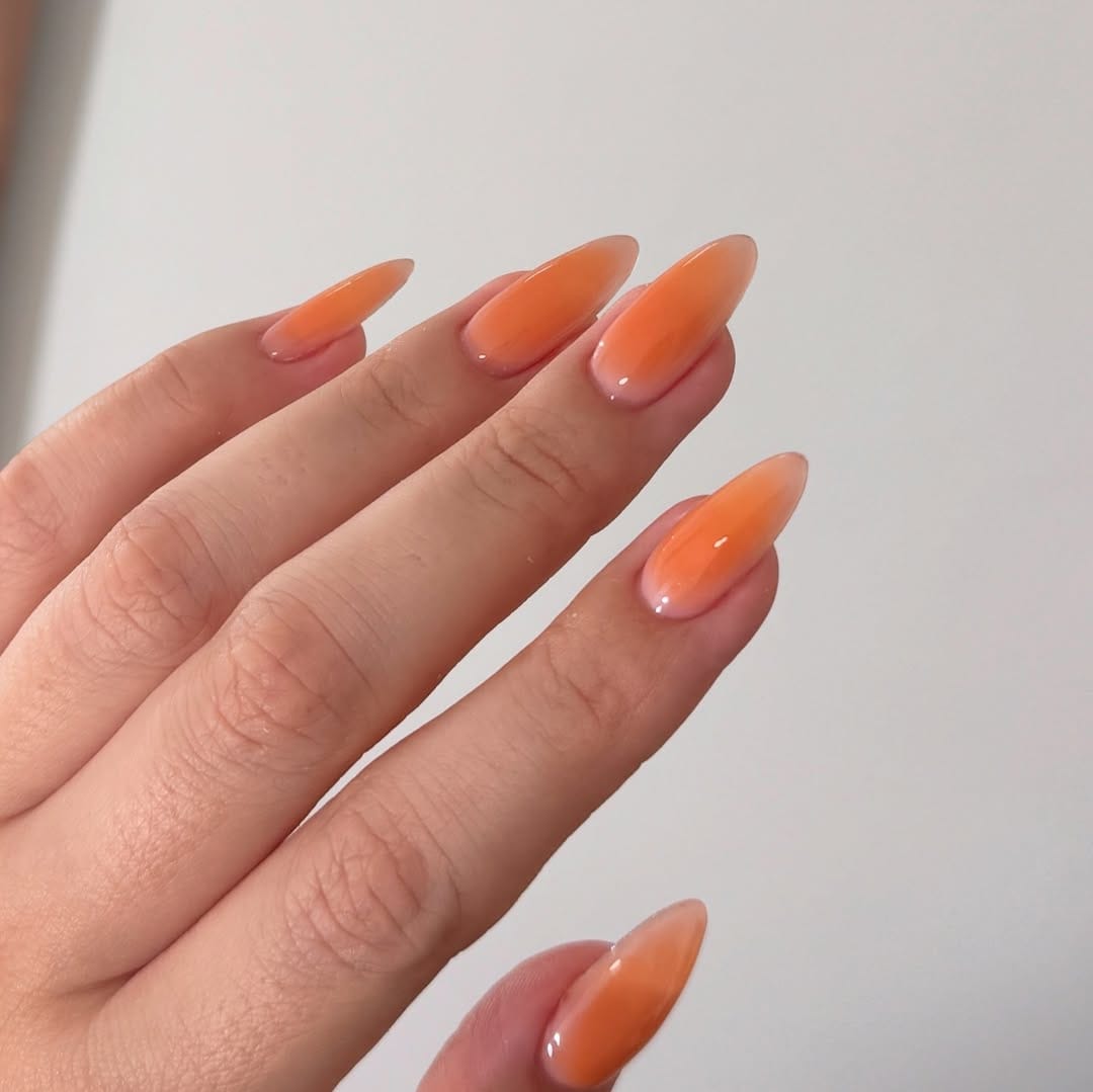 Orange jelly tip ombrƩ engagement nails with glossy finish