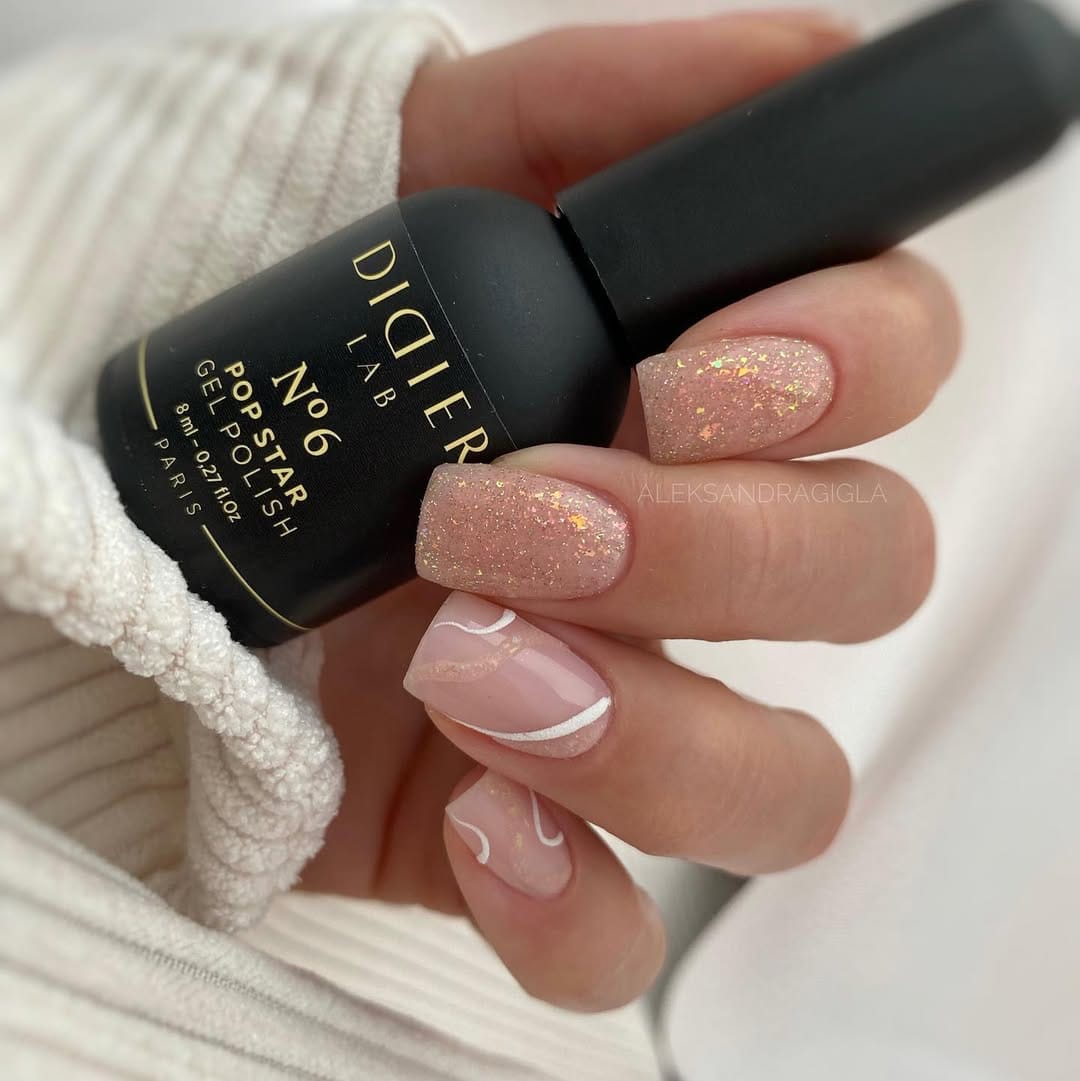 Champagne glitter swirl nails with sheer blush accent for a june nail idea
