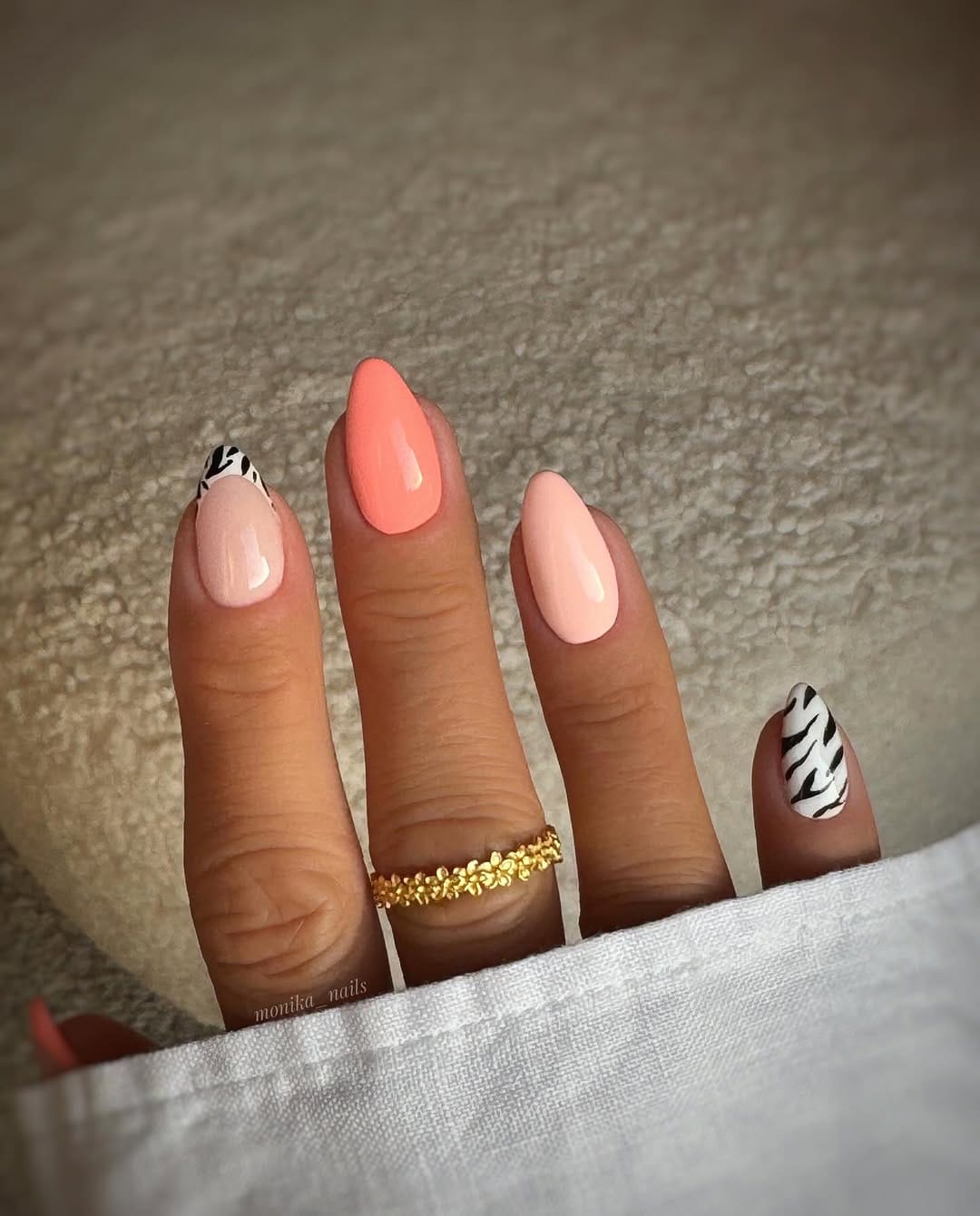 Coral and zebra print accent nails for a bold june nail design
