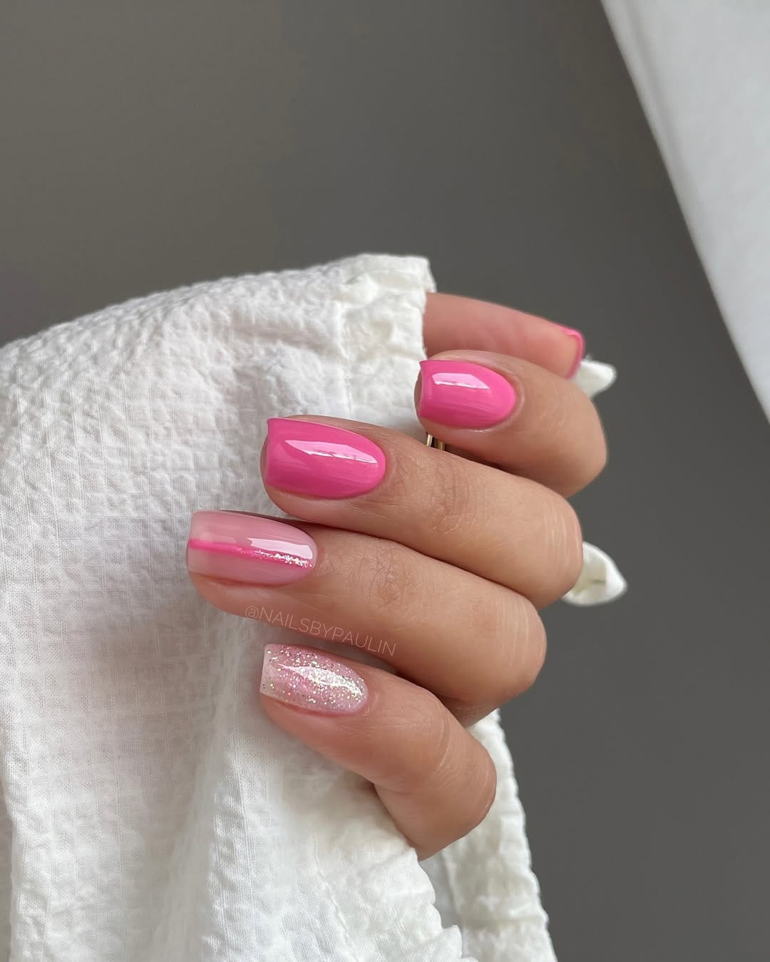Hot pink nails with holographic glitter accent for a june nail idea