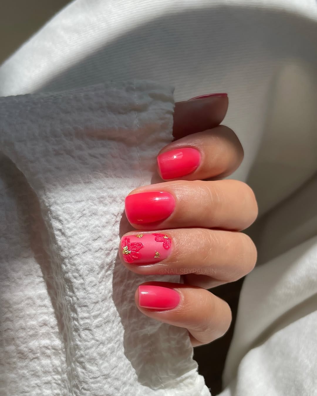 Watermelon pink jelly nails with 3D floral accent for a june nail idea