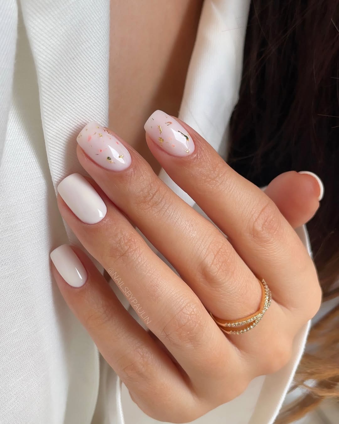 White and blush nails with scattered gold foil for a minimal june nail design