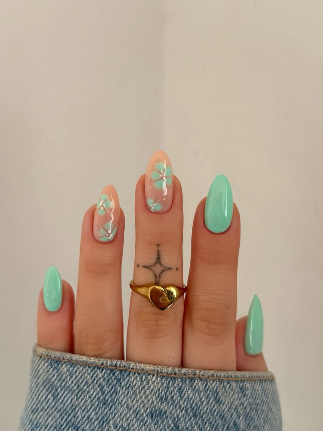 Mint green nails with sheer blossom branch accent for june nails