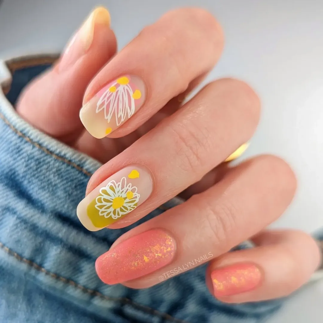 Peach aurora nails with white daisy and gold flake detail for june nails