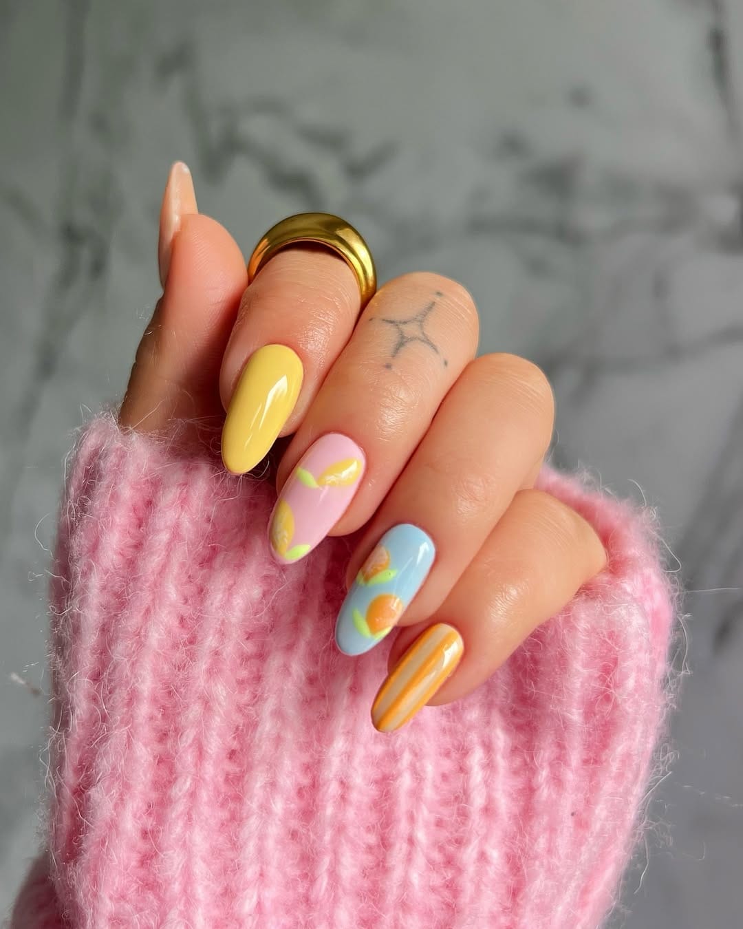 Citrus fruit nail art in yellow pink blue and orange for a fun june nail design