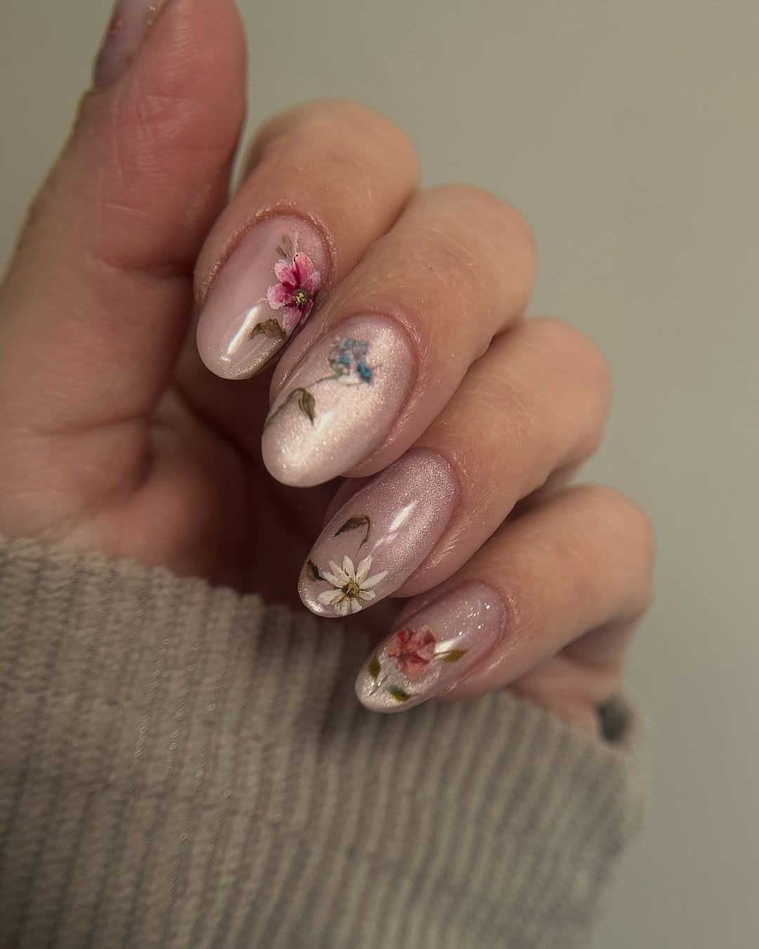Pressed flower sheer lilac nails with botanical blooms for a june nail idea