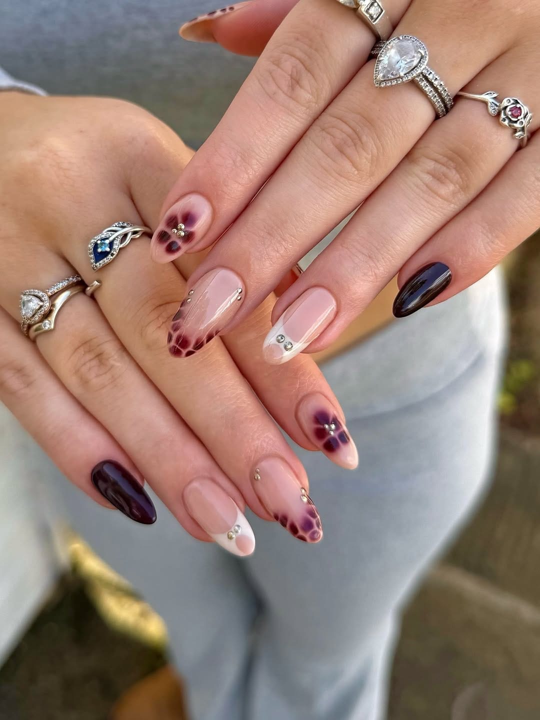 Dark plum floral and rhinestone almond nails for a dramatic nail trend 2026