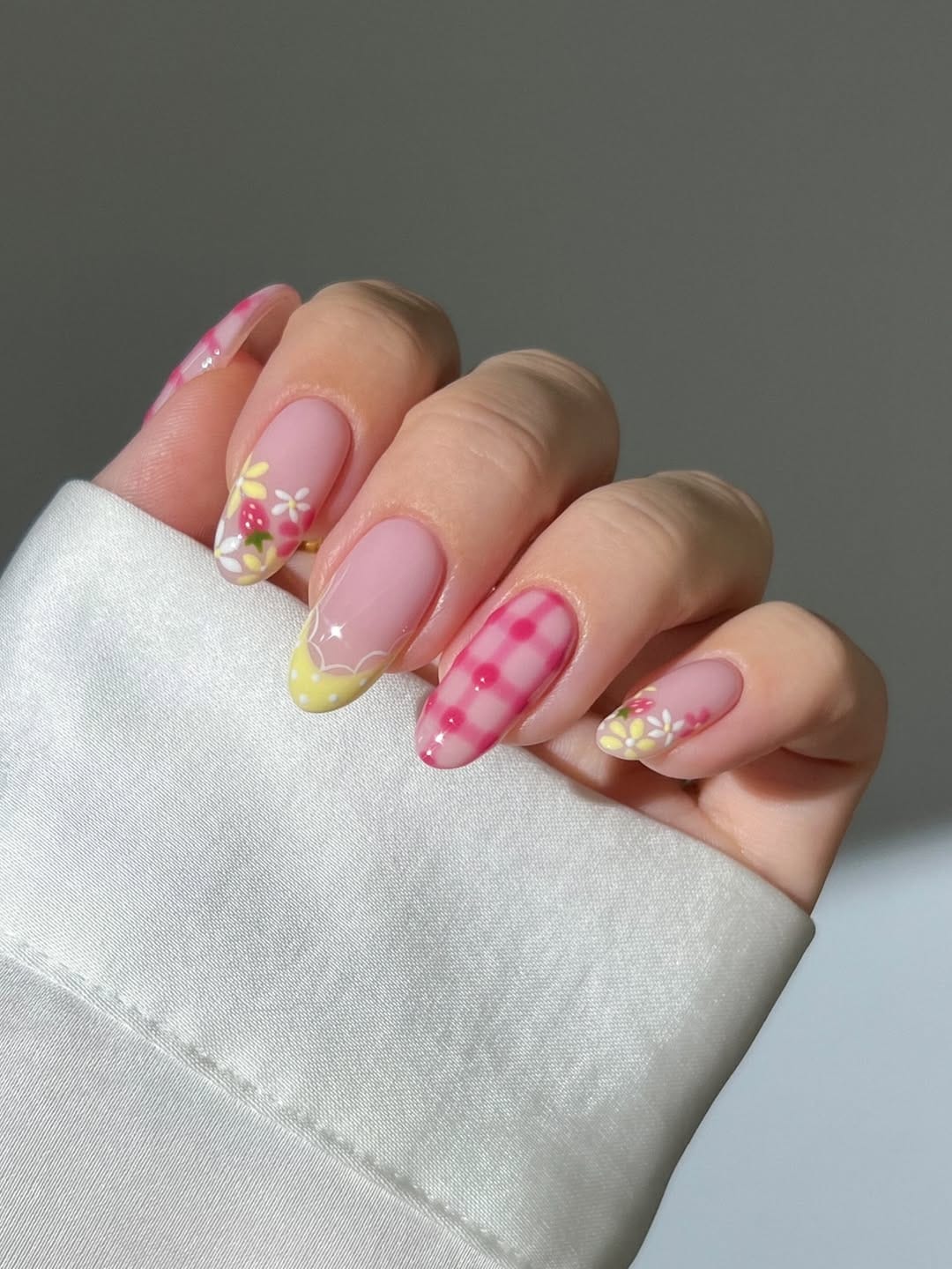 Pink gingham and strawberry nail art for a playful nail trend 2026