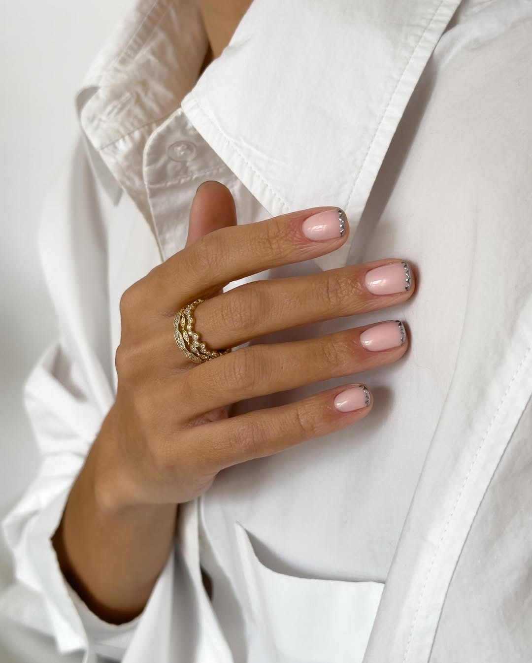 Blush pink nails with silver scallop French tips for an elegant nail trend 2026