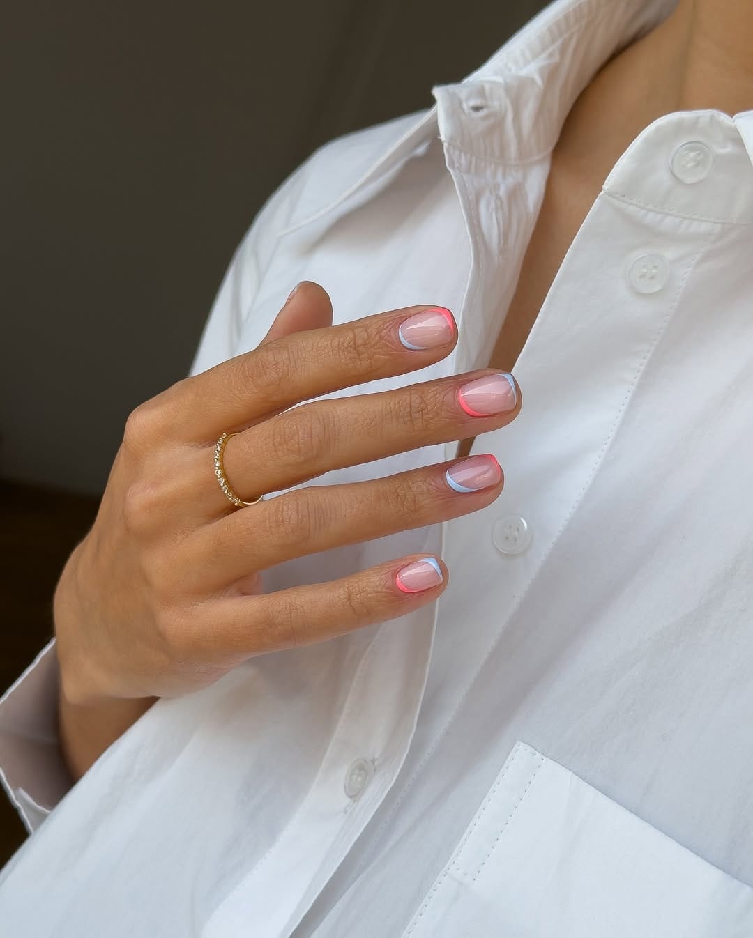 Short sheer nails with double French tips in coral and blue shades