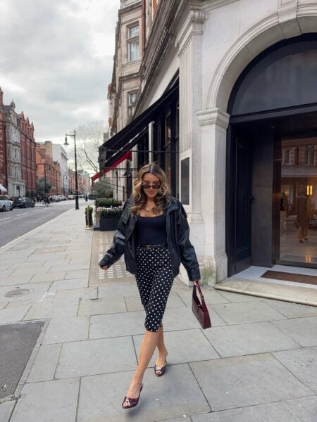 Polka dot capri pants outfit with black bodysuit and leather jacket