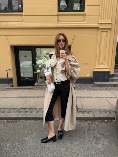Corset top with long trench coat and black capri pants outfit