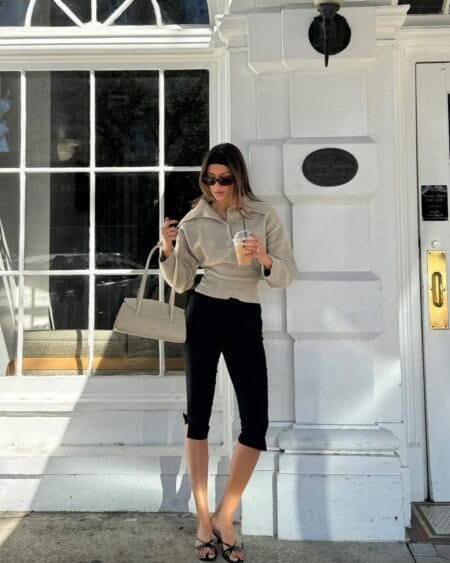 Oatmeal polo knit top with black capri pants and strappy heels