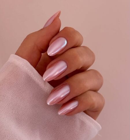 Long almond nails in full pearlescent pink chrome finish with iridescent mirror-like shine
