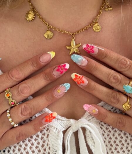 Almond nails with hand-painted hibiscus flowers, gingham French tips in blue and pink, bubble texture and gold starfish motifs