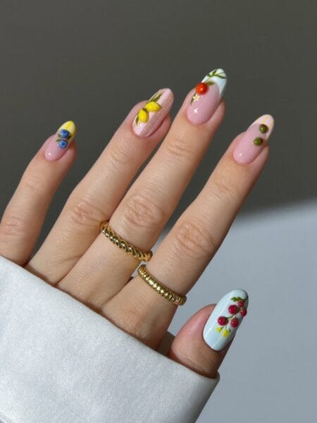 Mix-and-match French nails with hand-painted Mediterranean fruits including lemons, cherries, tomatoes and olives on a sheer base