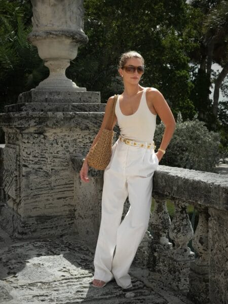 All-white wide-leg trousers with gold-studded belt chic July outfit
