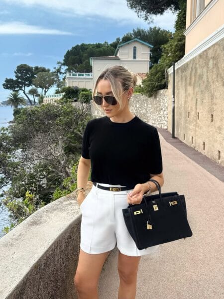 Black knit tee with white tailored shorts and gold belt summer July outfit