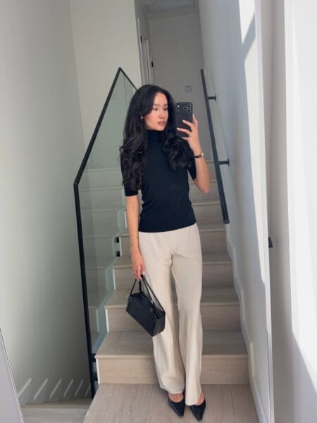 Black turtleneck knit top with stone wide-leg trousers stylish July outfit