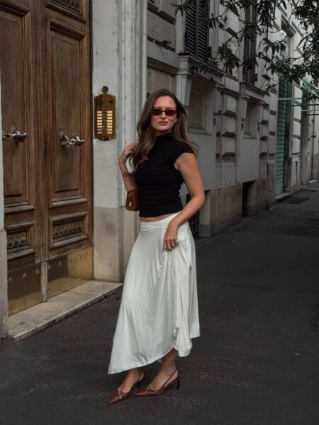 Black short-sleeve turtleneck crop top and white draped satin asymmetric midi skirt with cognac slingbacks — summer everyday outfits