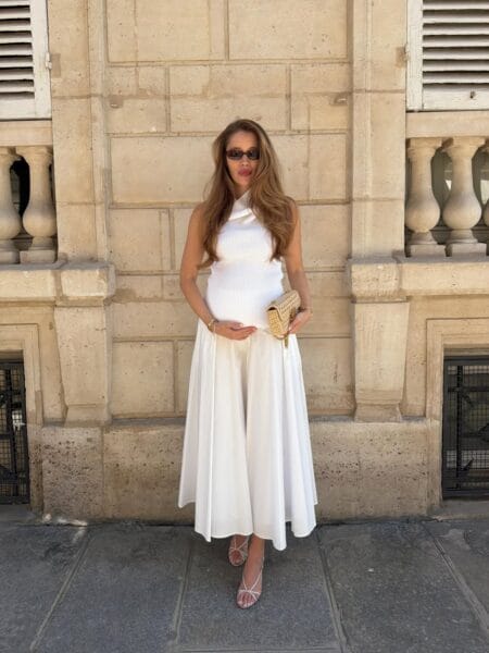 White ribbed cross-neck halter top and full ivory satin midi skirt with nude strappy heels and rattan clutch — june outfit ideas