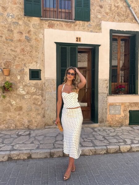 Cream and black polka dot corset halter top and matching midi skirt set with nude heeled sandals — trendy summer looks