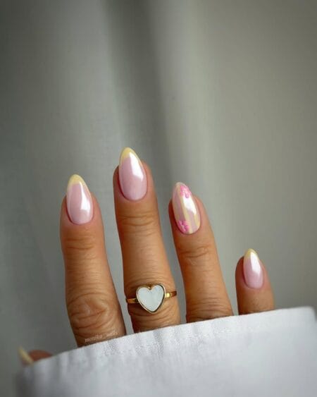 Butter yellow chrome French tip almond nails with pink floral stripe accents.