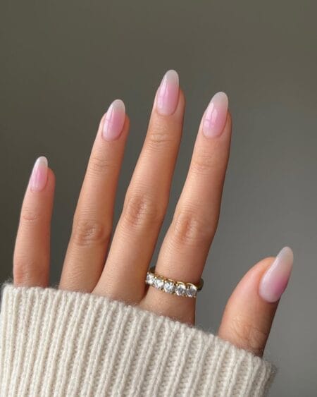 Soft pink-to-white ombré almond nails with a seamless gradient finish.