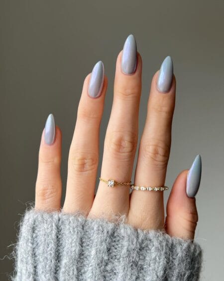 Steel blue-grey almond nails with a pearl chrome finish and glossy shine.