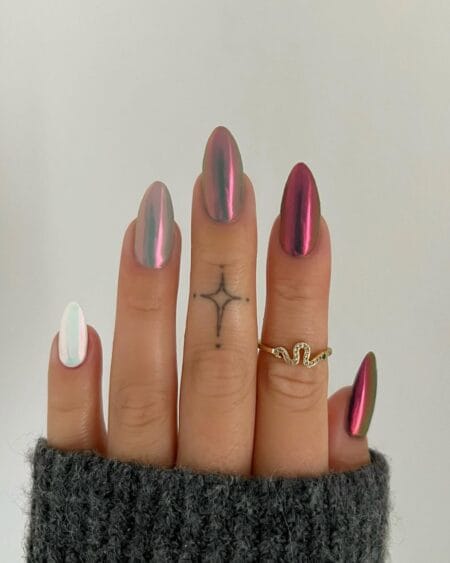 Reflective duochrome chrome almond nails with a color-shifting metallic finish.