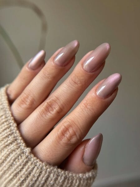 Mauve almond nails with a luminous pearl shimmer and glossy finish.